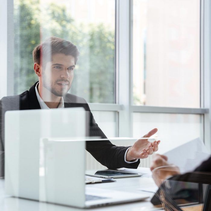 two-businessmen-with-laptop-on-business-meeting-PBZ4EJ3.jpg